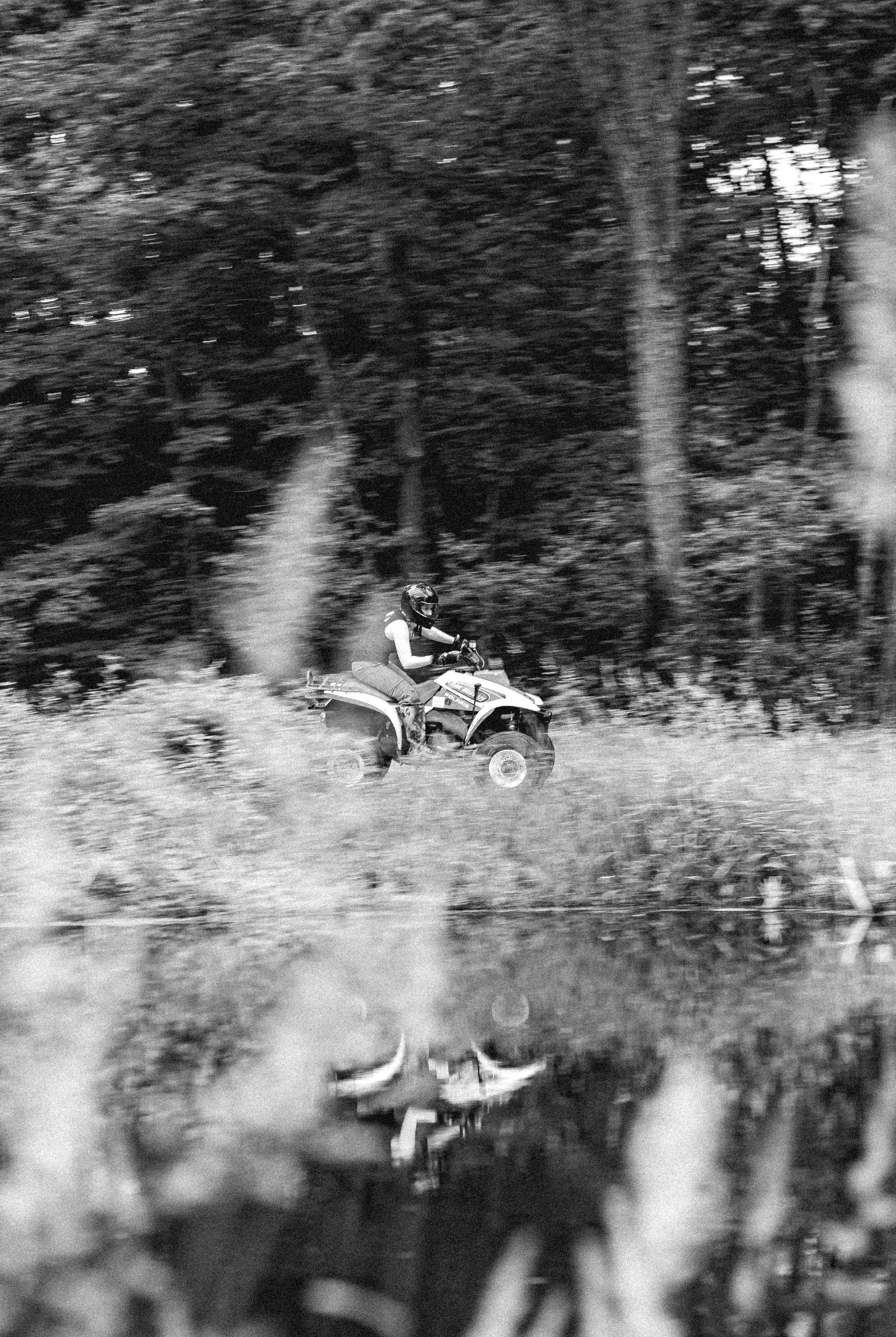grayscale photo of motorcycle on grass field